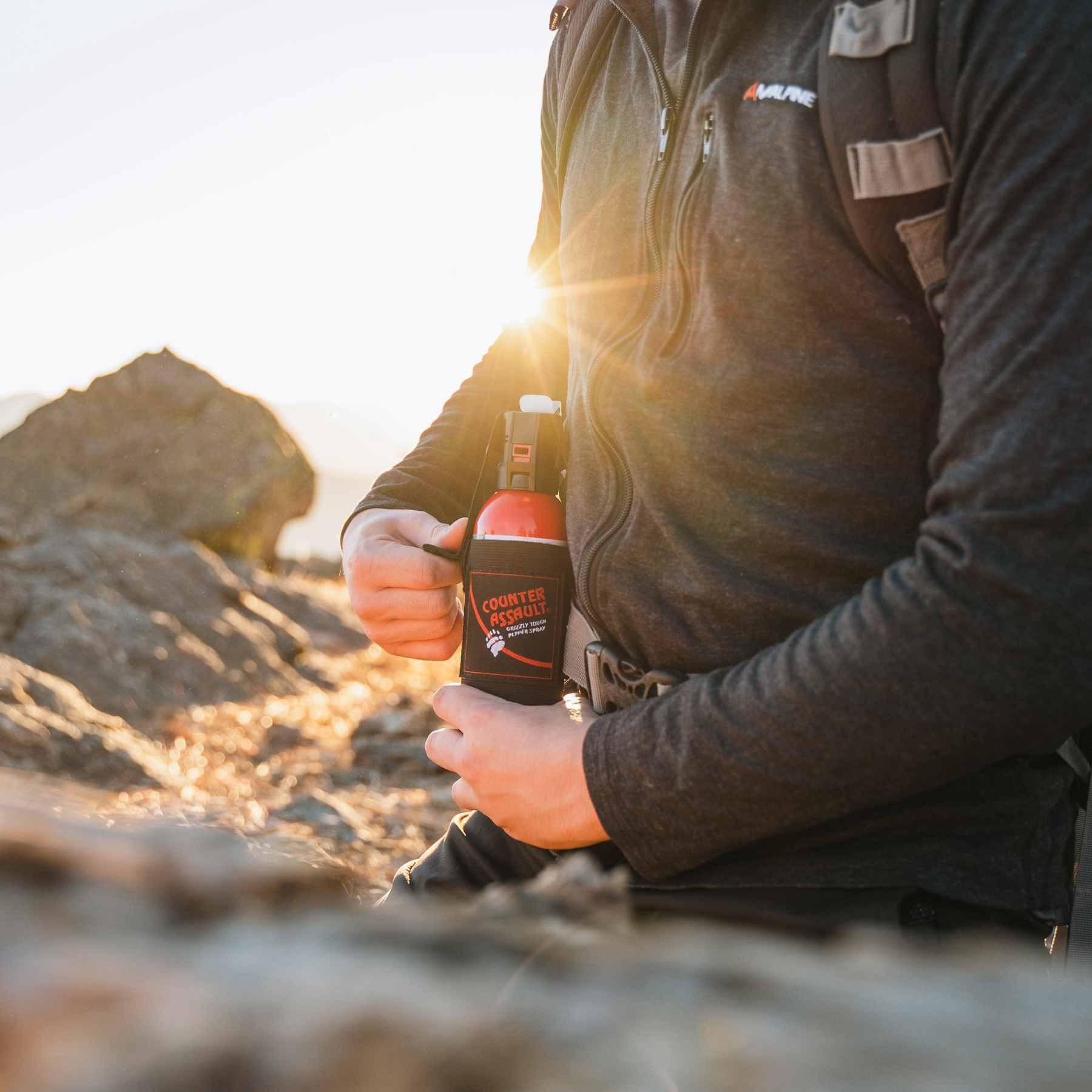 Man with a Counter Assault bear deterrent spray attached