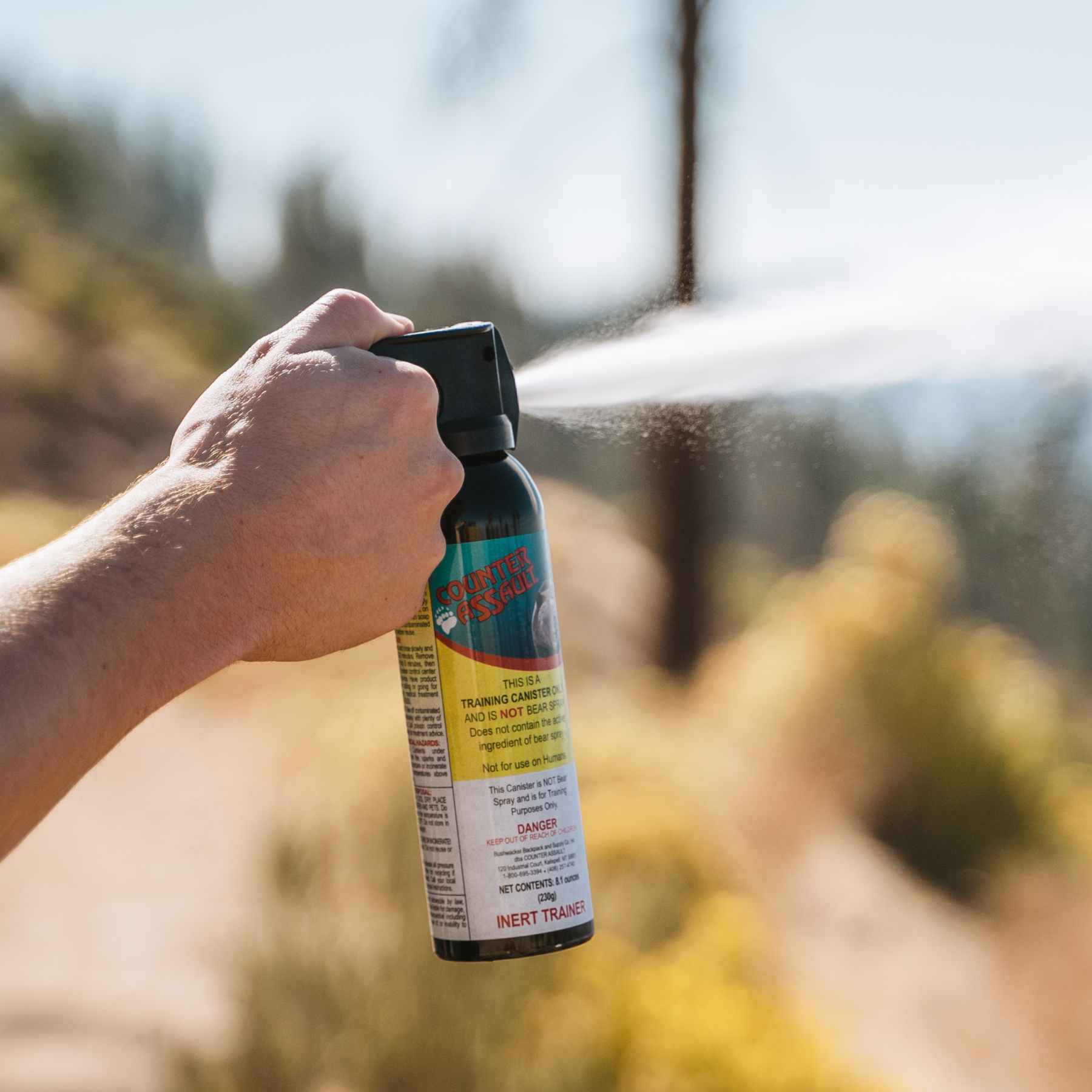 Man spraying with a training canister