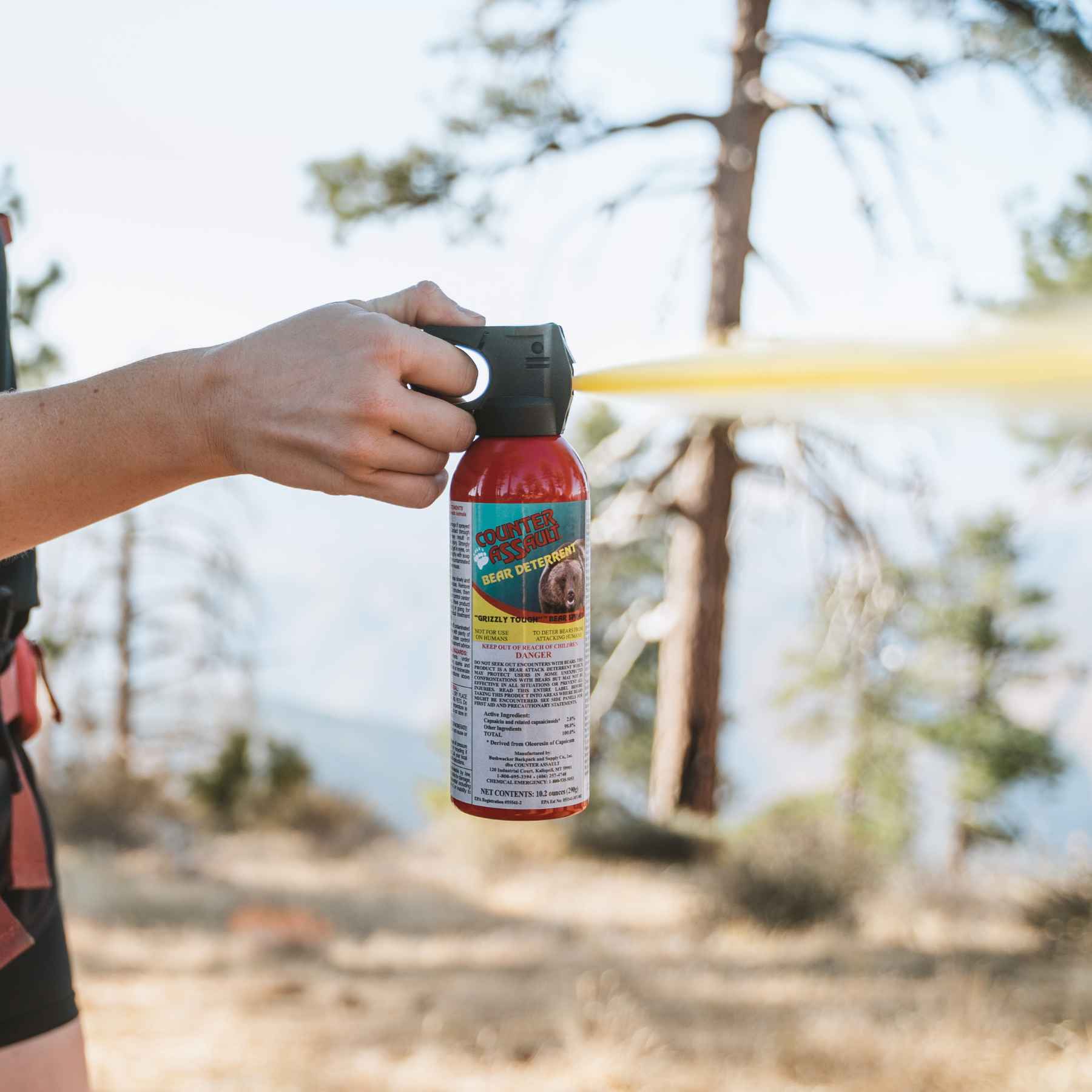 Woman spraying with a Counter Assault bear deterrent spray