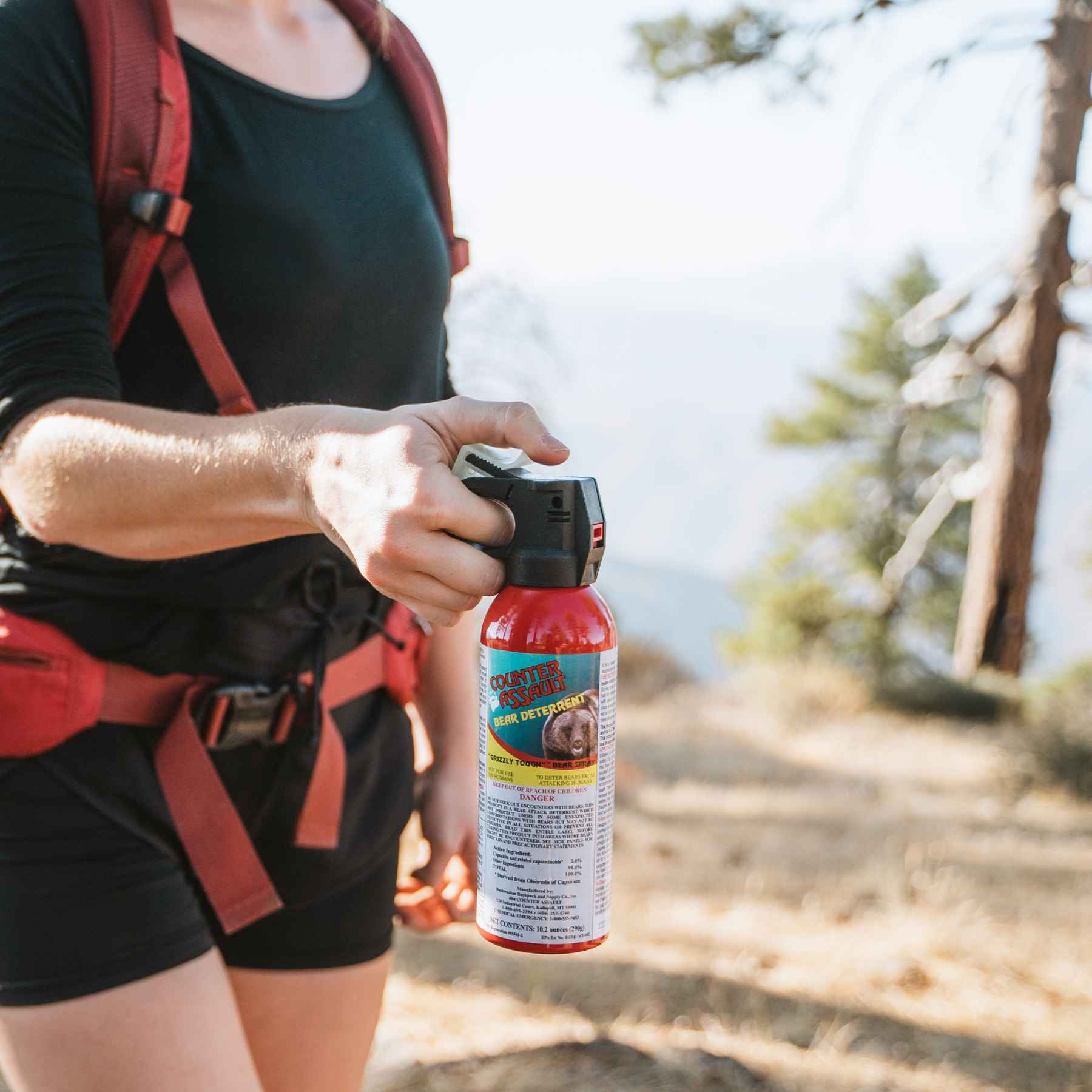 Woman using a Counter Assault bear deterrent spray
