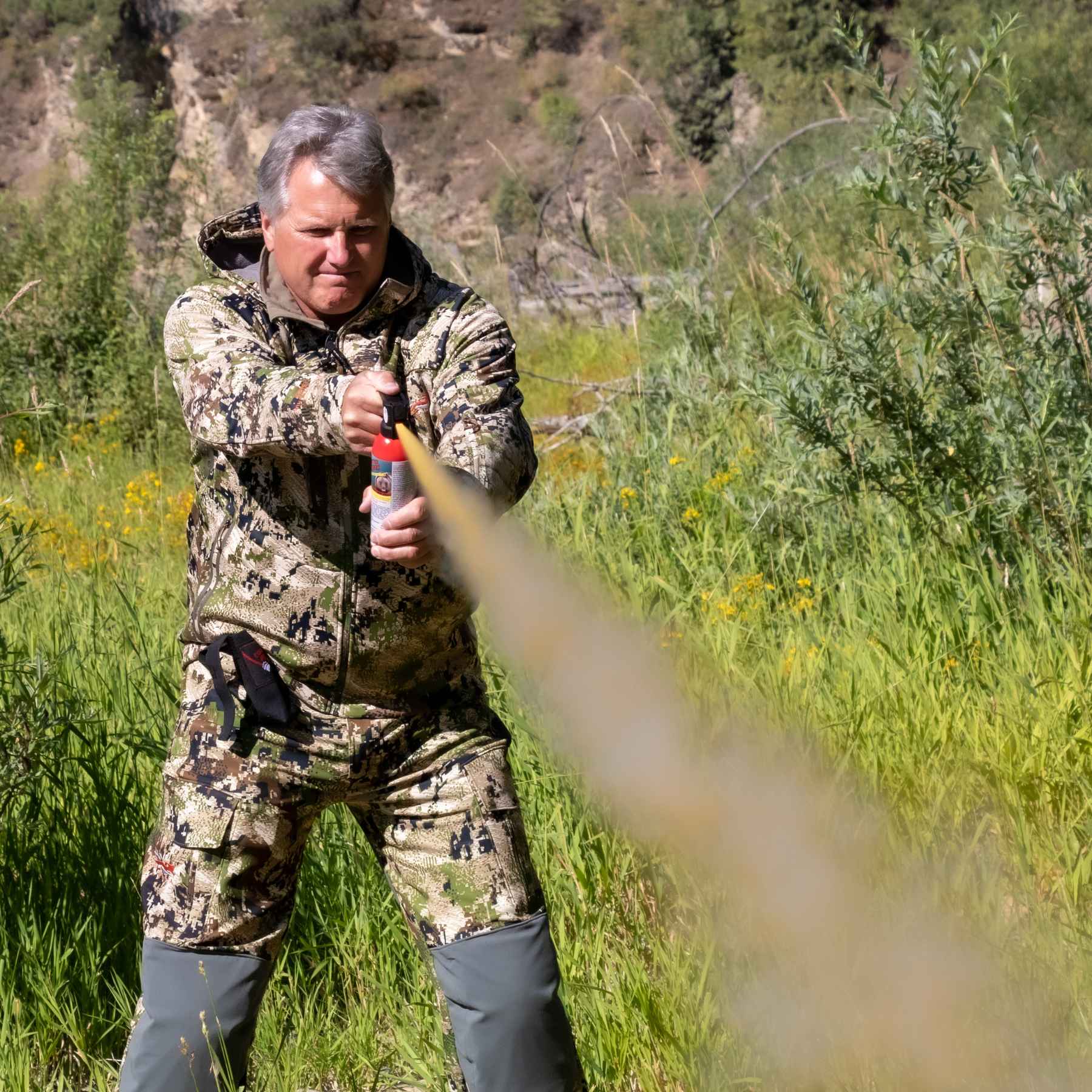 Man spraying with the Counter Assault bear deterrent spray