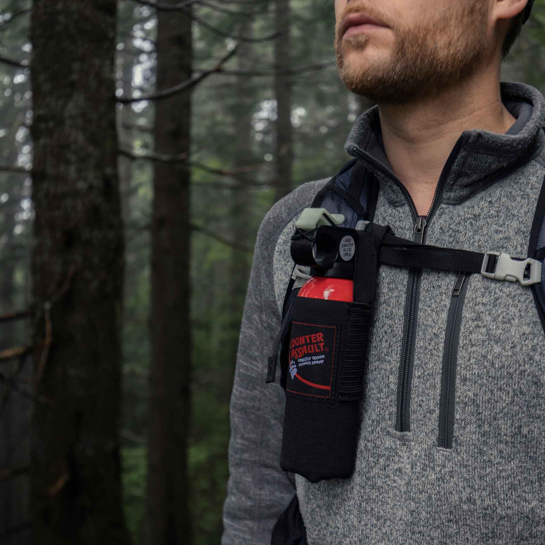 Man with a Counter Assault bear deterrent attached to his bag