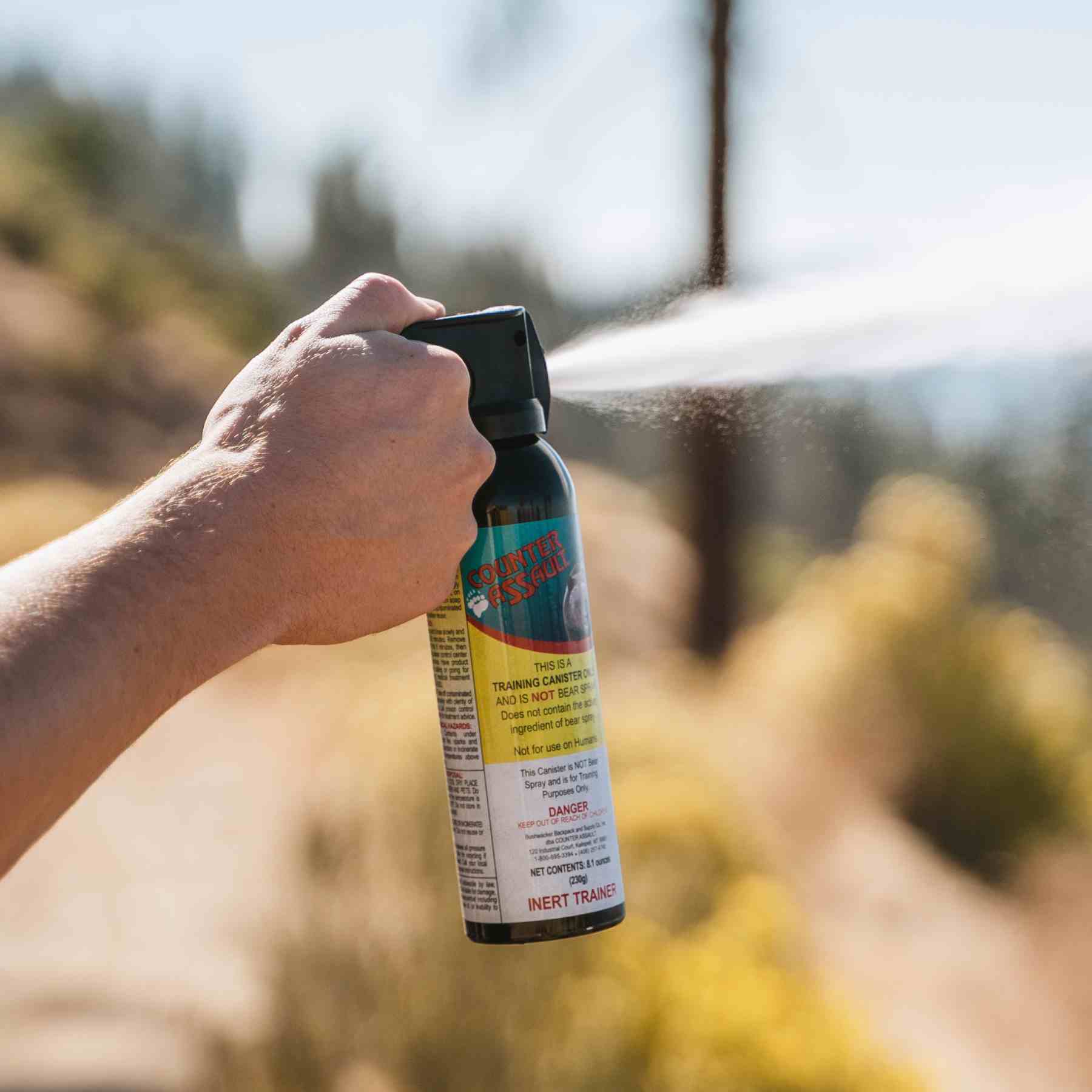 Man spraying with a training canister