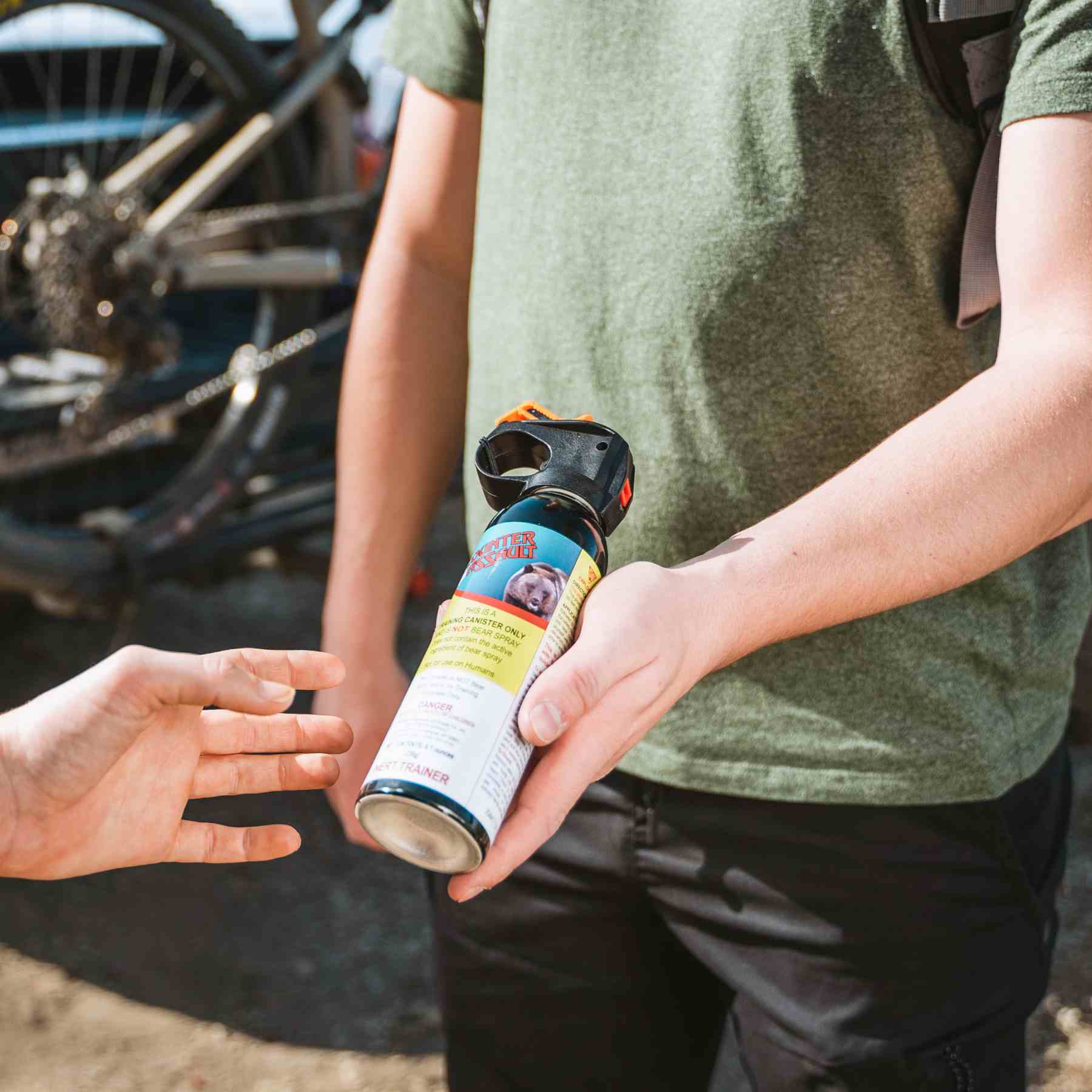 Man handing a training canister to someone