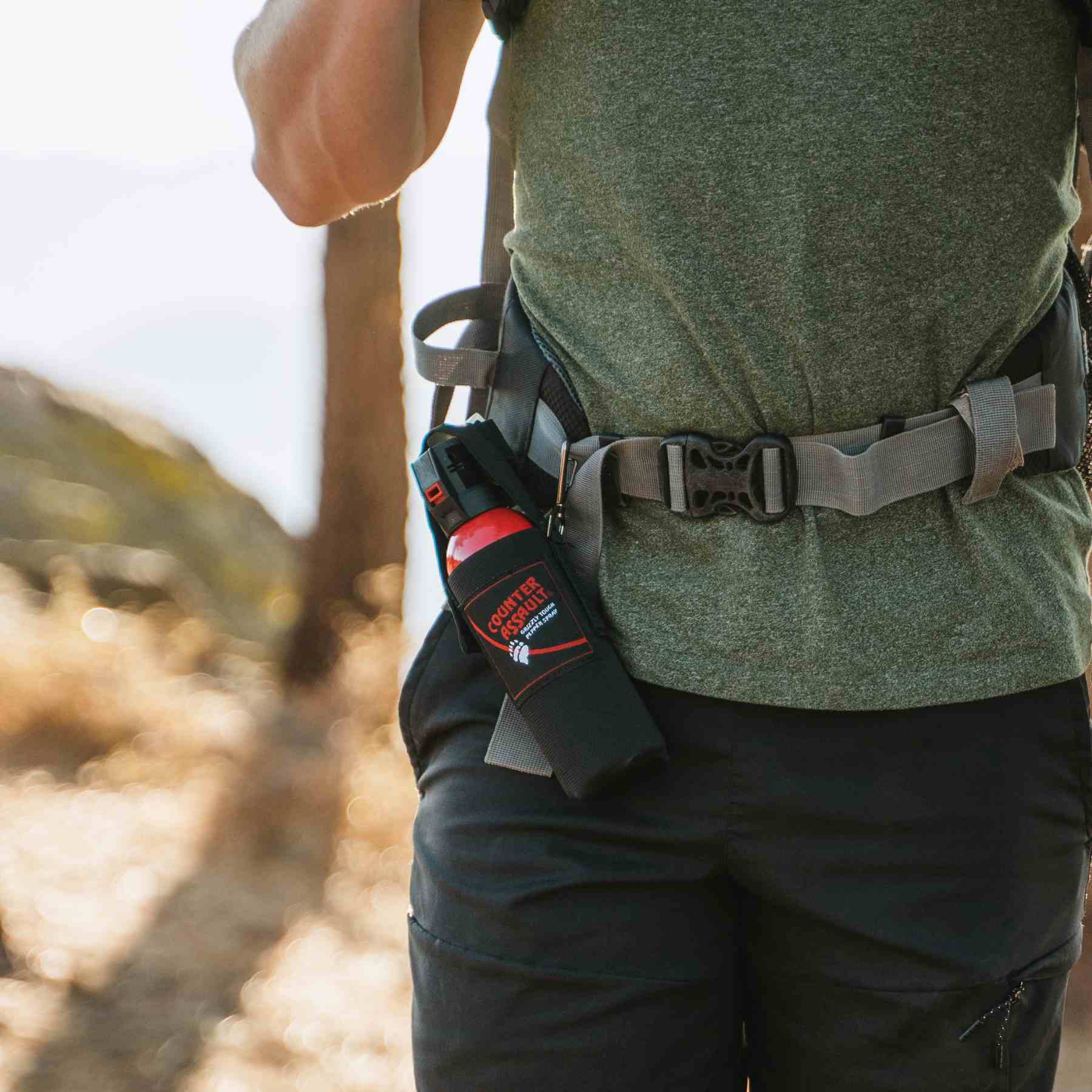 Man with a Counter Assault bear deterrent spray attached