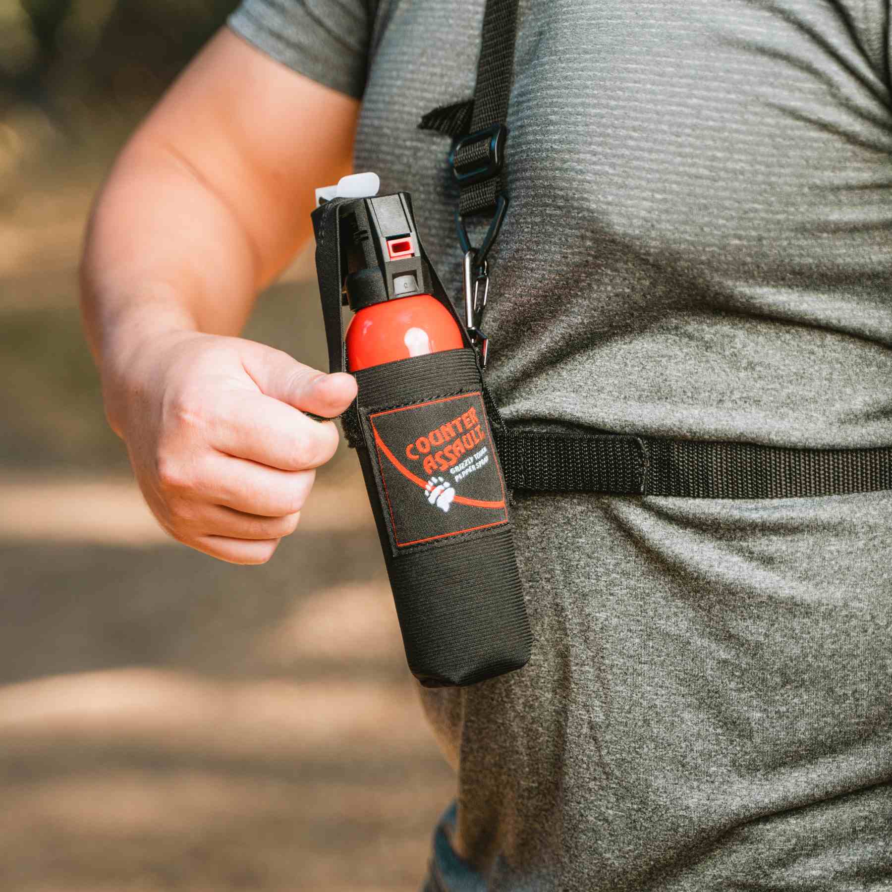 Man with a holster for Counter Assault bear deterrent spray