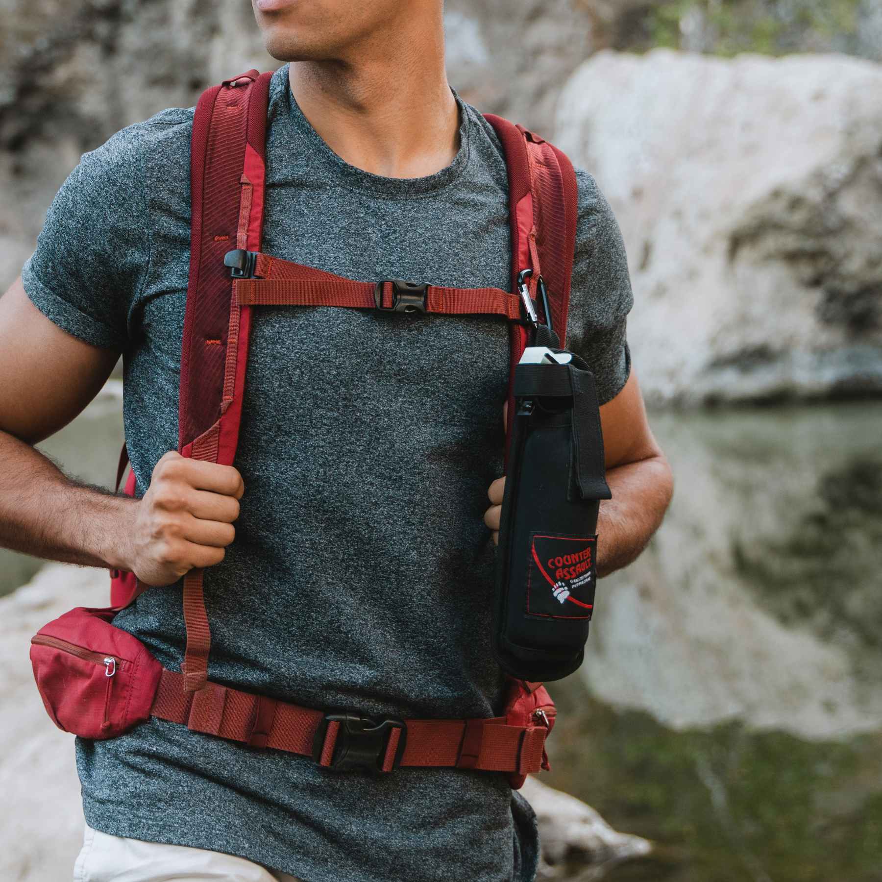 Man with a bear spray holster attached to bag