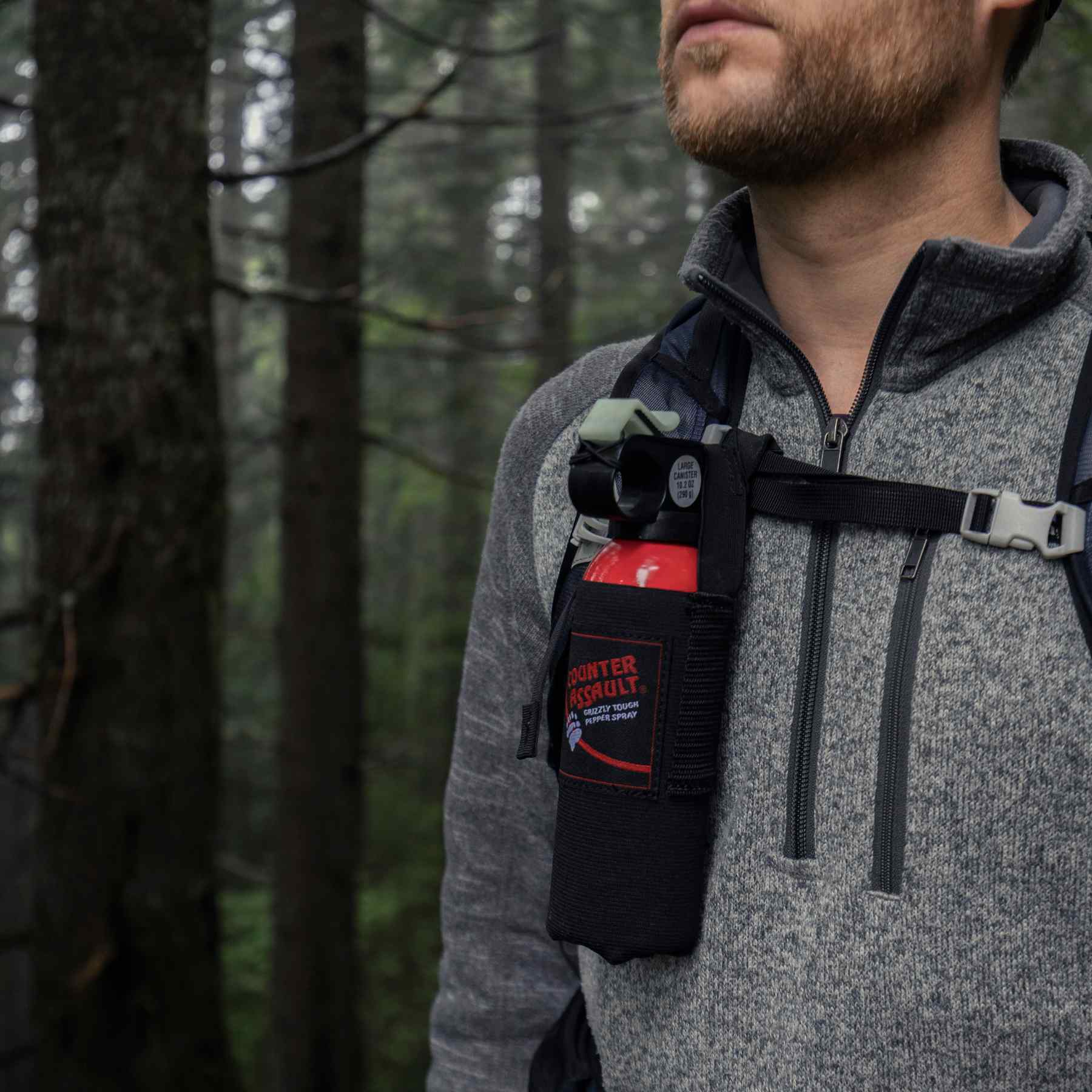 Man with a bear spray universal belt holster attached