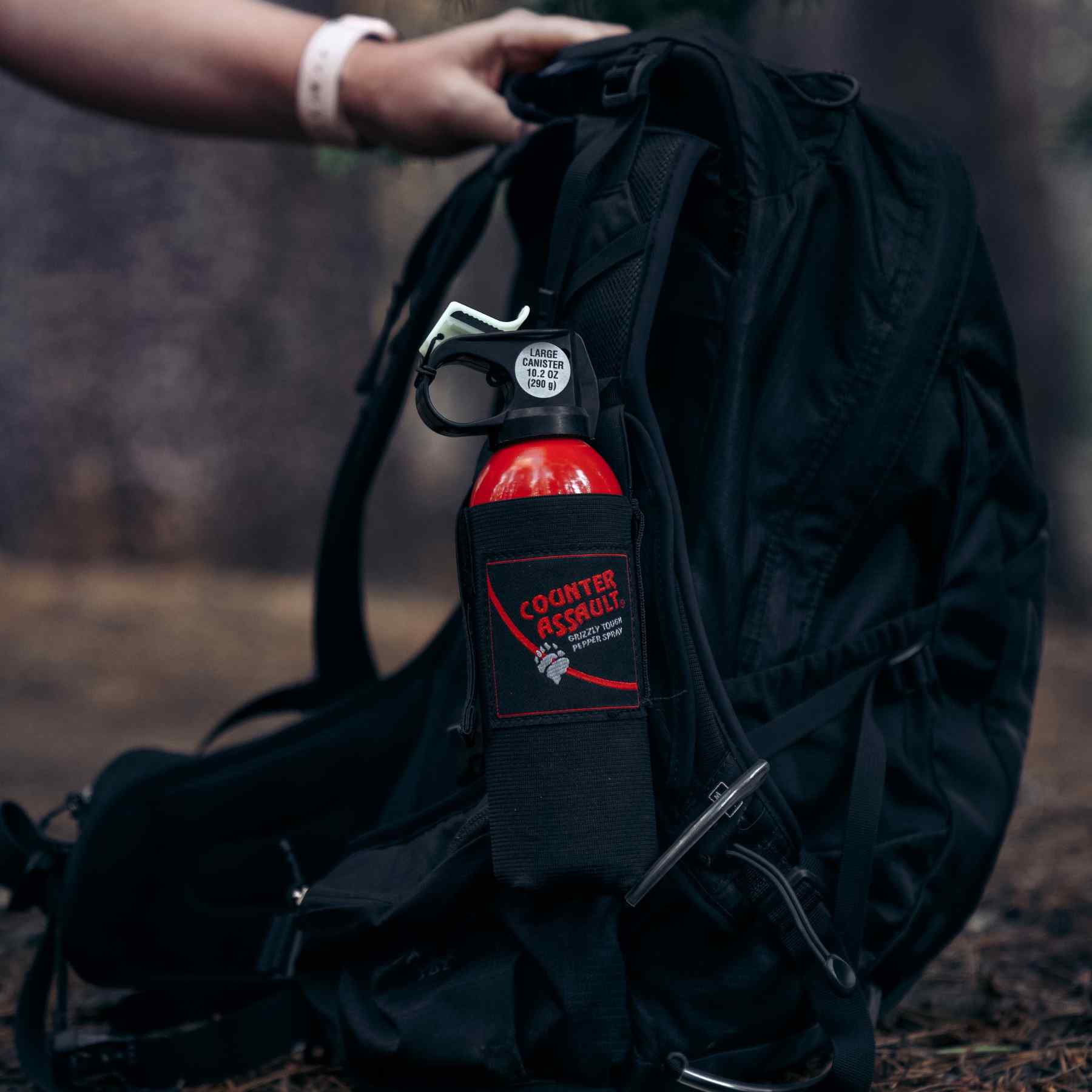 Bear spray inside the holster attached to a bag