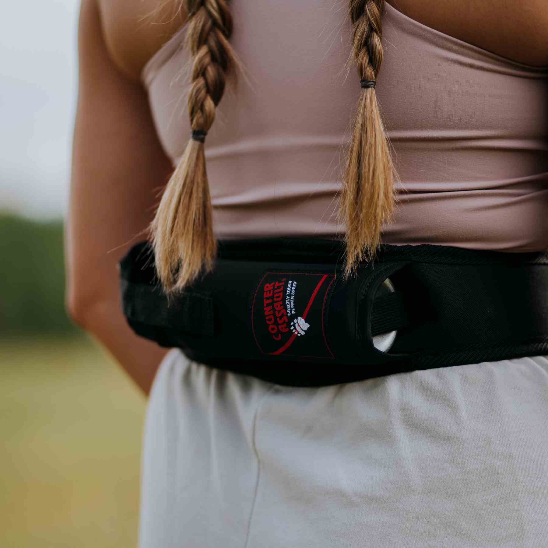 Woman with a trail runner holster attached