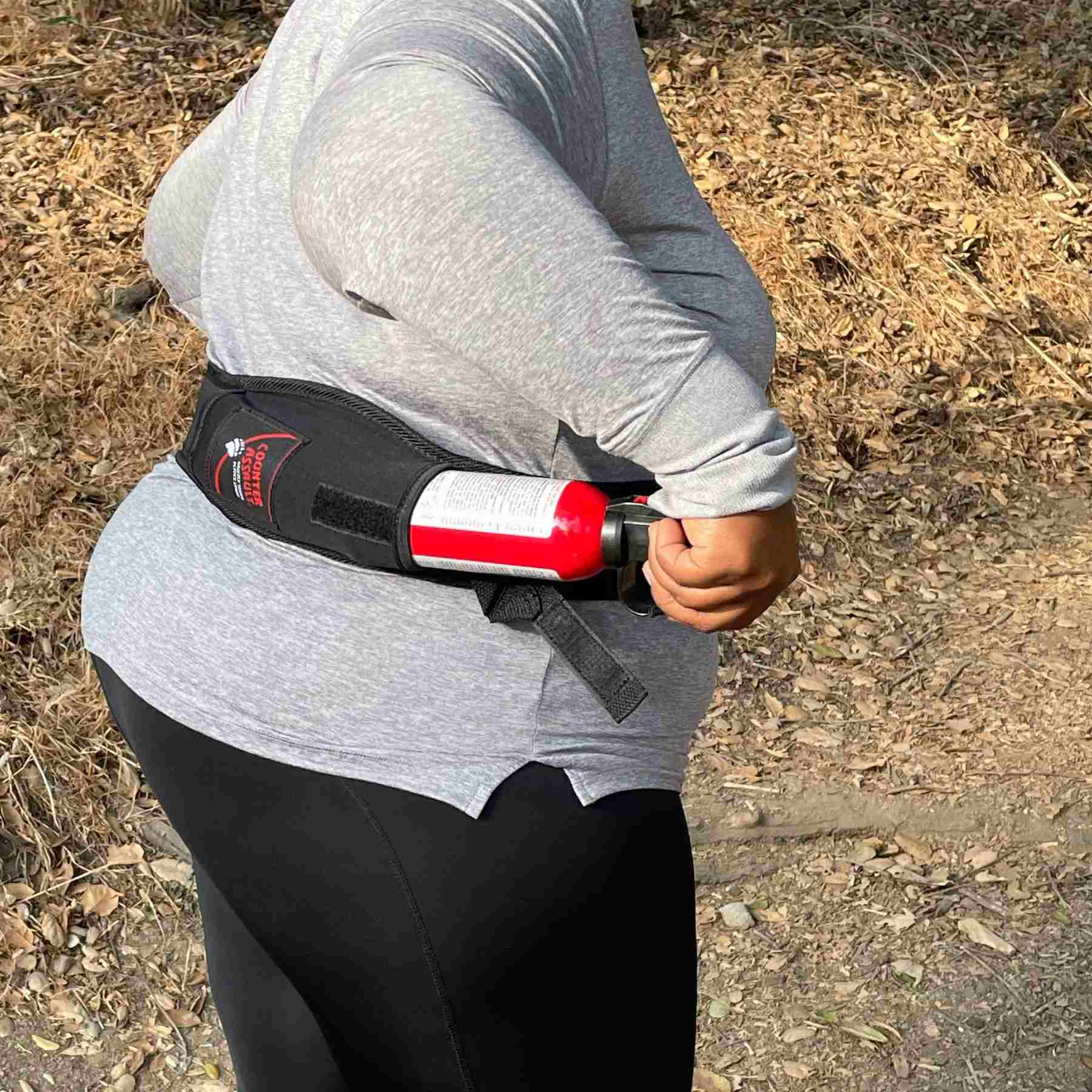 Woman putting a bear spray inside the holster