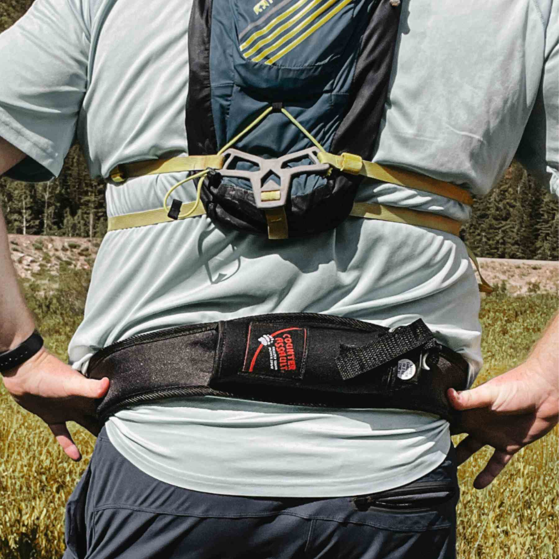 Man with a trail runner holster attached