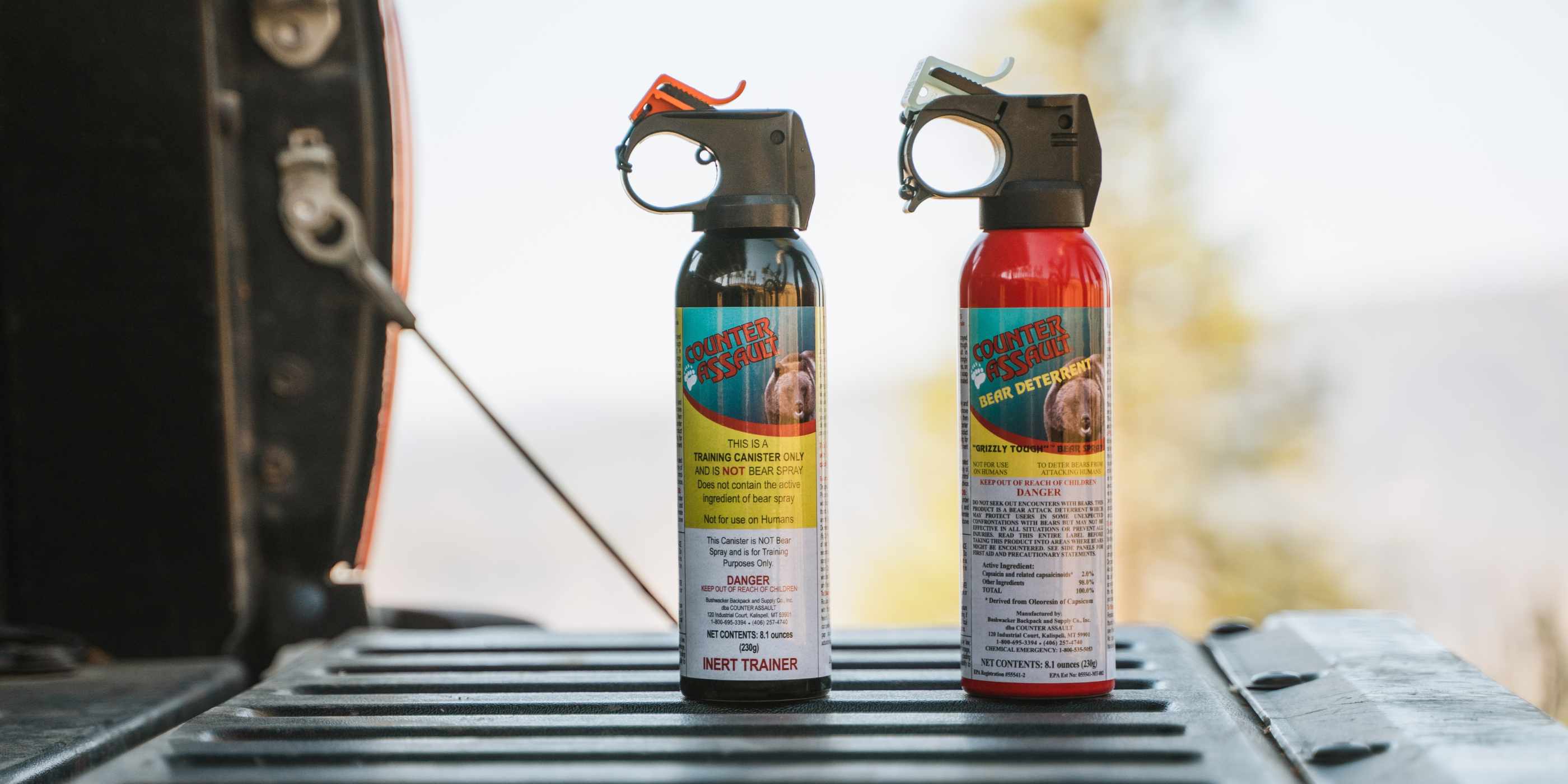 8.1 oz bear spray and training canister on back of truck