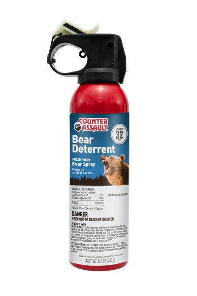 A tall red can of bear deterrent spray. The spray head is black with a white safety wedge. There' a product label on the body of the can. From Left to Right, top to bottom it reads:
"Counter Assault" as a logo; "Range up to 32 Feet"; "Bear Deterrent; "GRIZZLY TOUGH Bear Spray Works On All Bear Species"; A Grizzly Bear; "Active Ingredients" listed; "Not for use on humans; Danger statement; First Aid statement; "See back label for additional precautionary statements"; "NEW WT. 8.1 OZ (230G)"