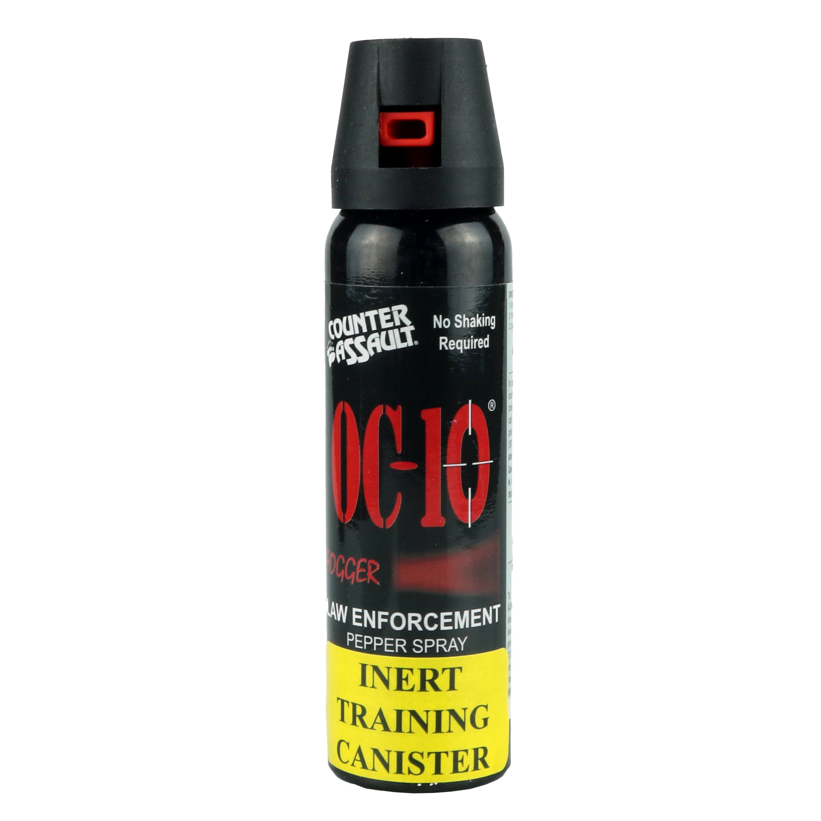 A small, tall black can of pepper spray. The spray head is black and forward facing, showing a red nozzle.  There' a product label on the body of the can. From Left to Right, top to bottom it reads:
"Counter Assault" as a logo; "No Shaking Required"; "OC-10"; "FOGGER" (followed by a wide spray pattern in red); "LAW ENFORCEMENT PEPPER SPRAY"
Below is a yellow sticker with black text saying: "INERT TRAINING CANISTER"