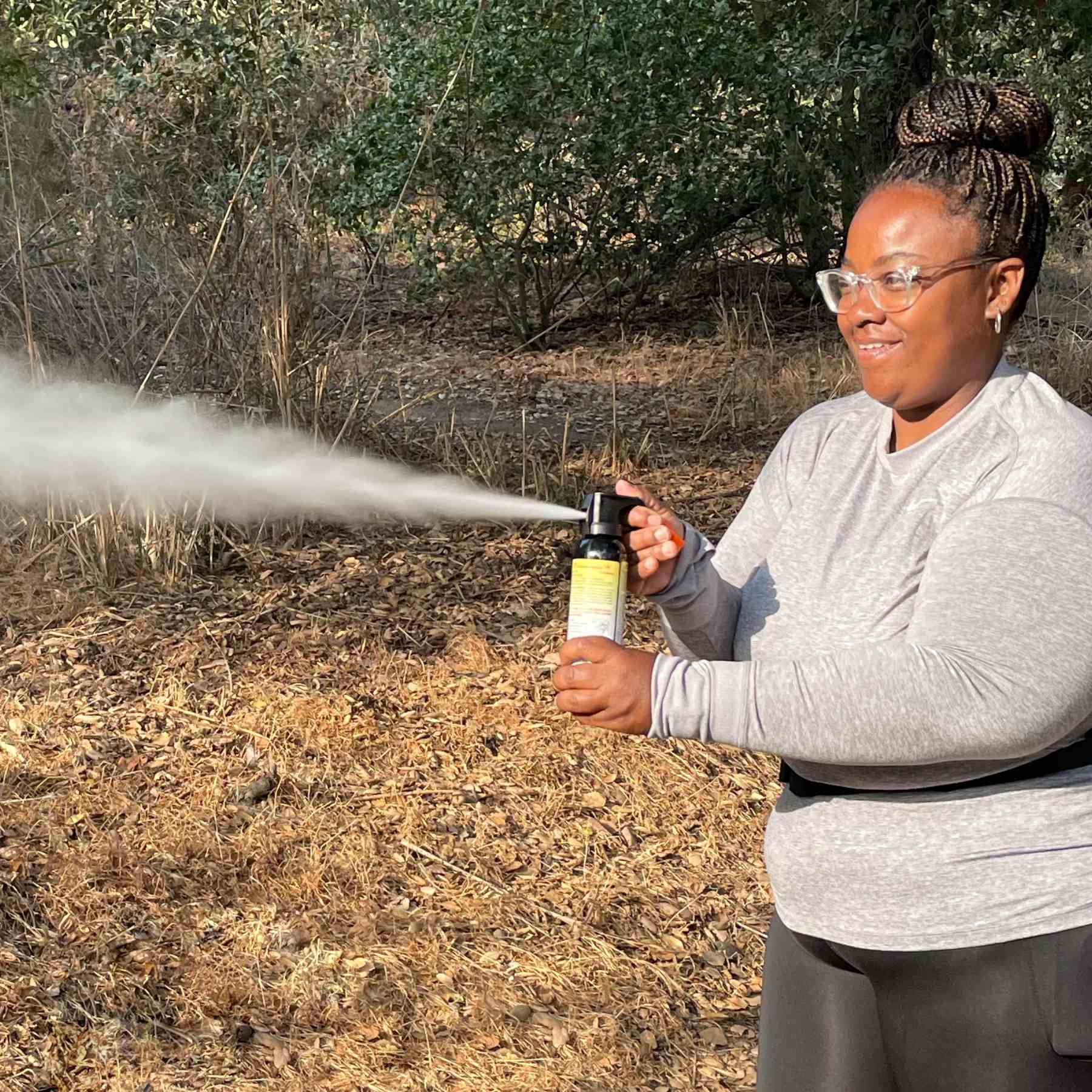 Woman spraying inert training canister.