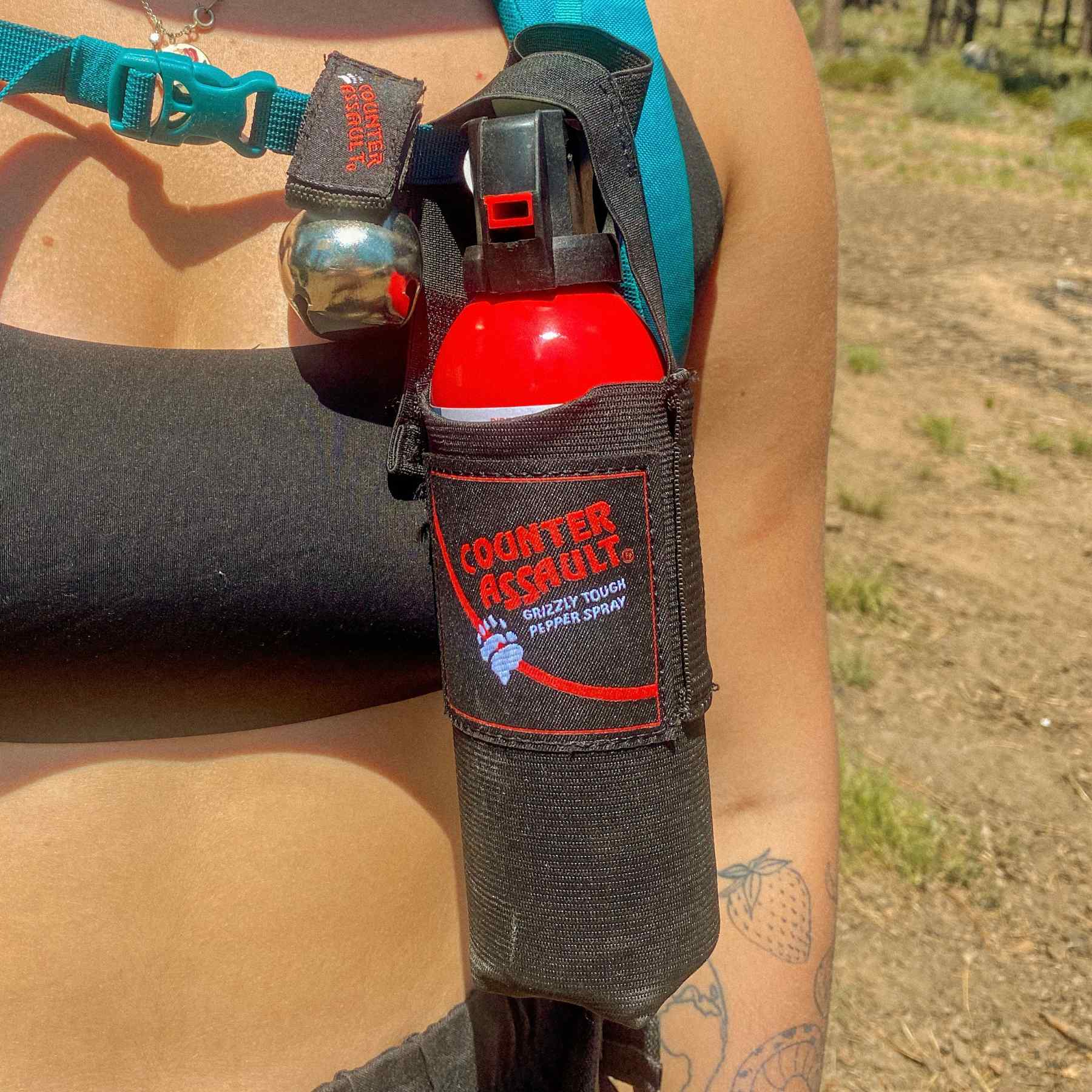 Woman with a bear spray universal belt holster attached