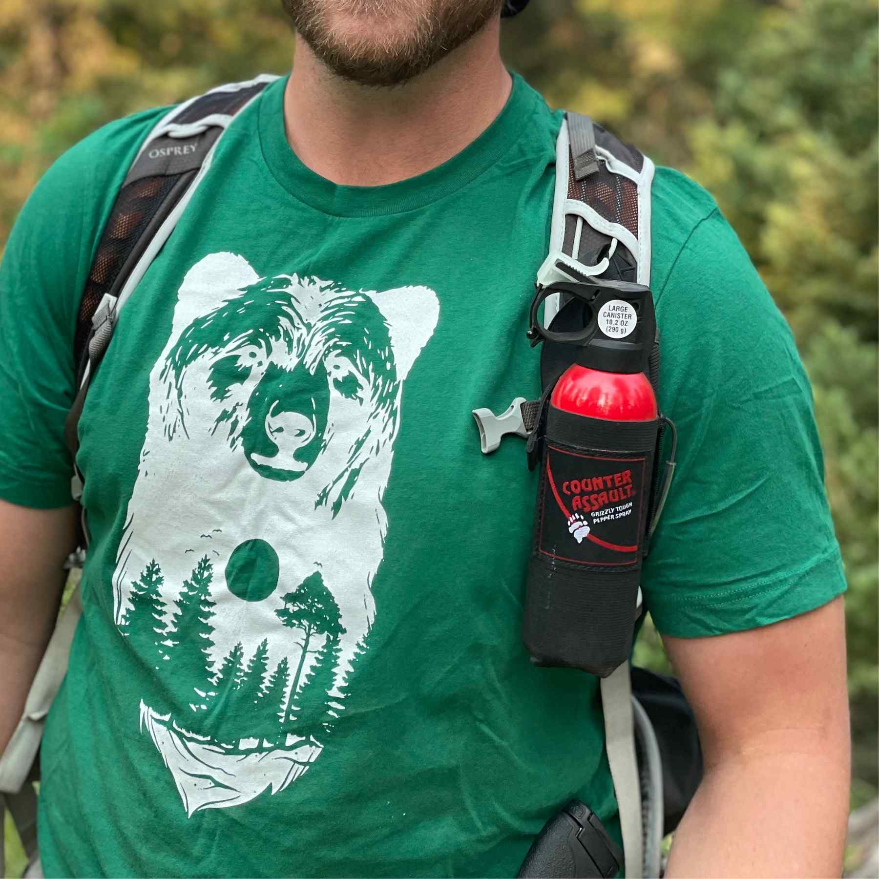 Man with a bear spray universal belt holster attached