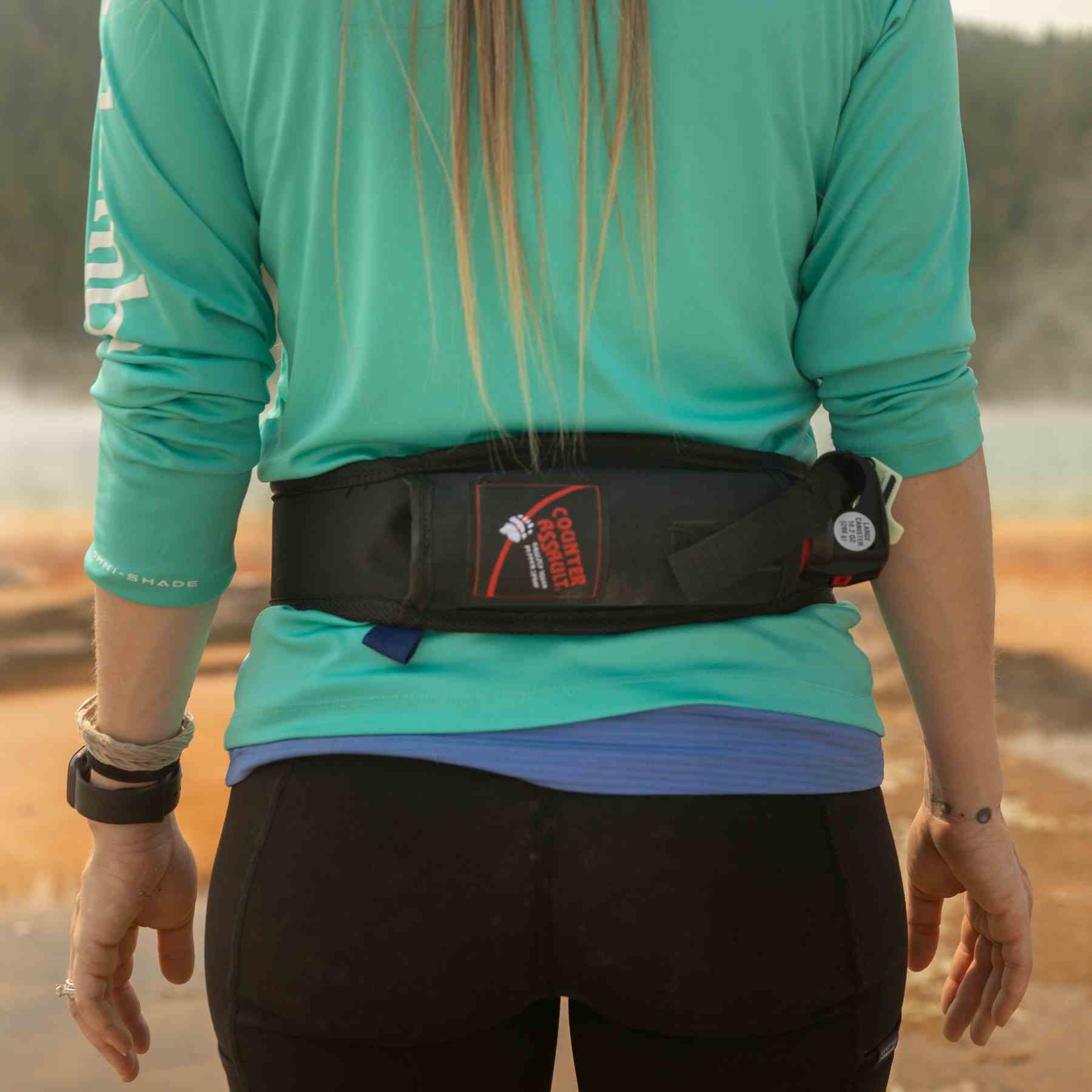 Woman with a trail runner holster attached